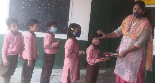 Children were welcomed by applying tilak in Mindkali village