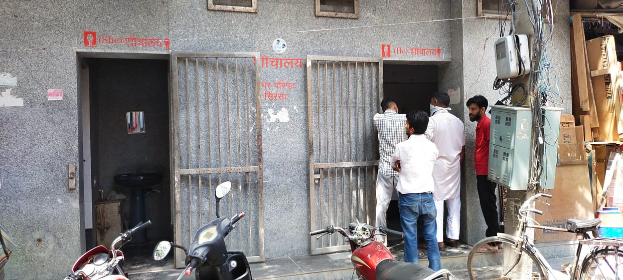 Locks hanging on public toilets made for women, dirt spread among men