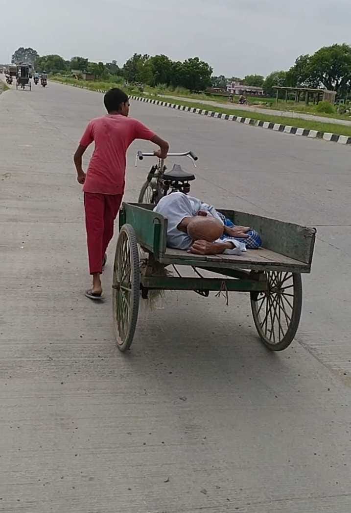 The child took the grandfather to the hospital on a handcart