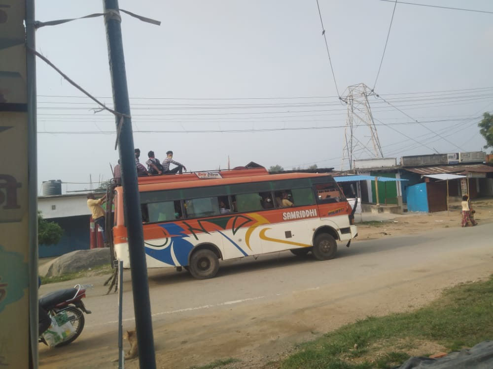 Students being carried on the roof of buses