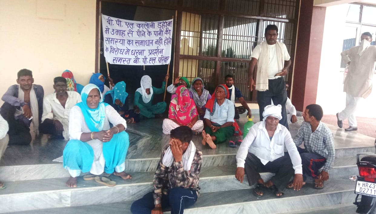 Villagers struggling with water problem, demonstrated by bursting a pot
