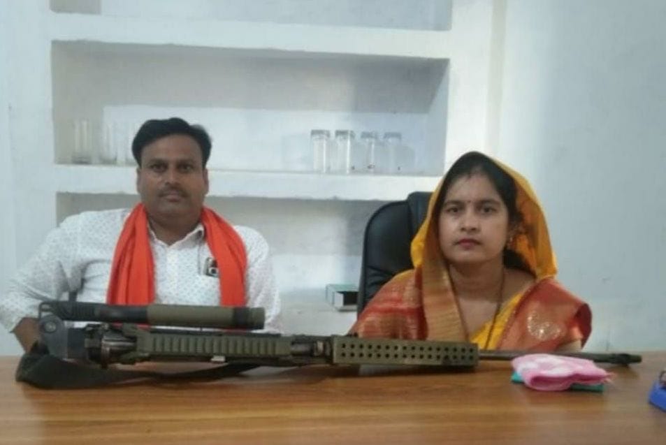 Rifle on table in block office, block chief on chair