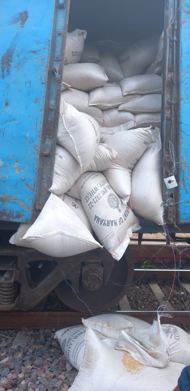 Wagon door of goods train broken, sacks hung