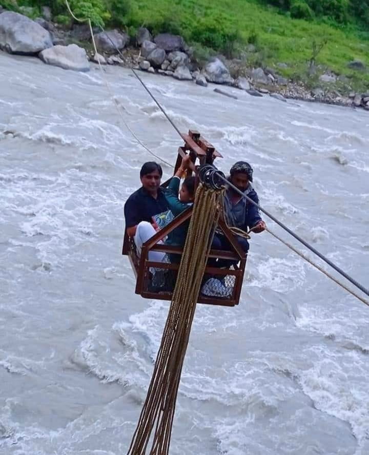 Health workers reached Hudki by crossing the river by trolley for vaccination