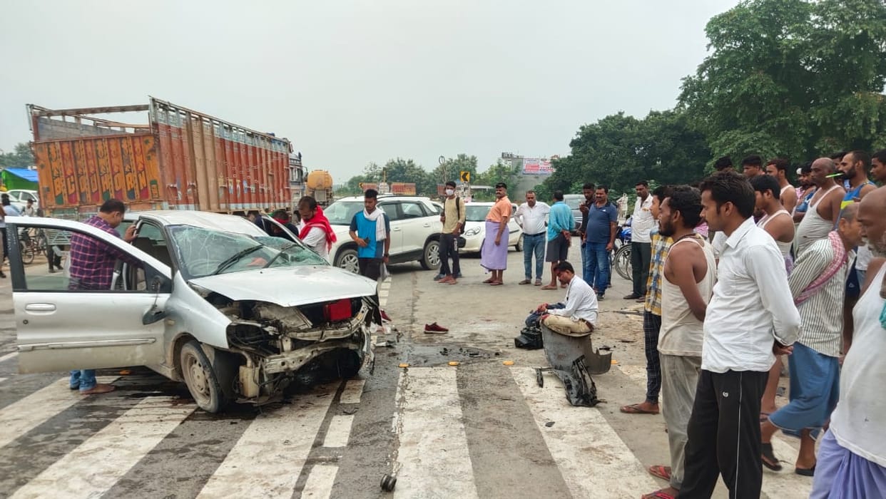 Car overturned after colliding with divider, three injured