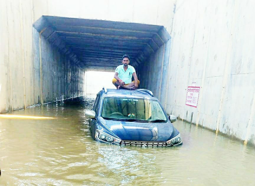 etawah news,The car started sinking in the underpass, saved life by sitting on the roof