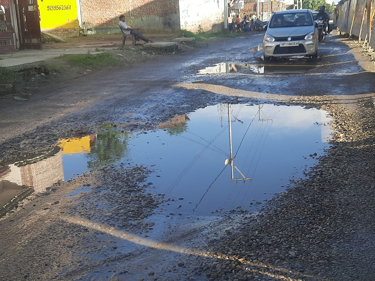 The ongoing construction of the bridge, the approach road turned into potholes