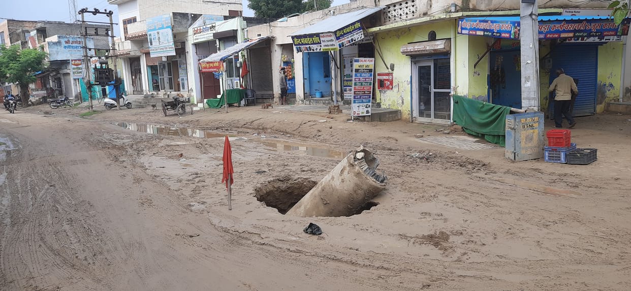 A muddy road sunken on Apollo Road in the rain