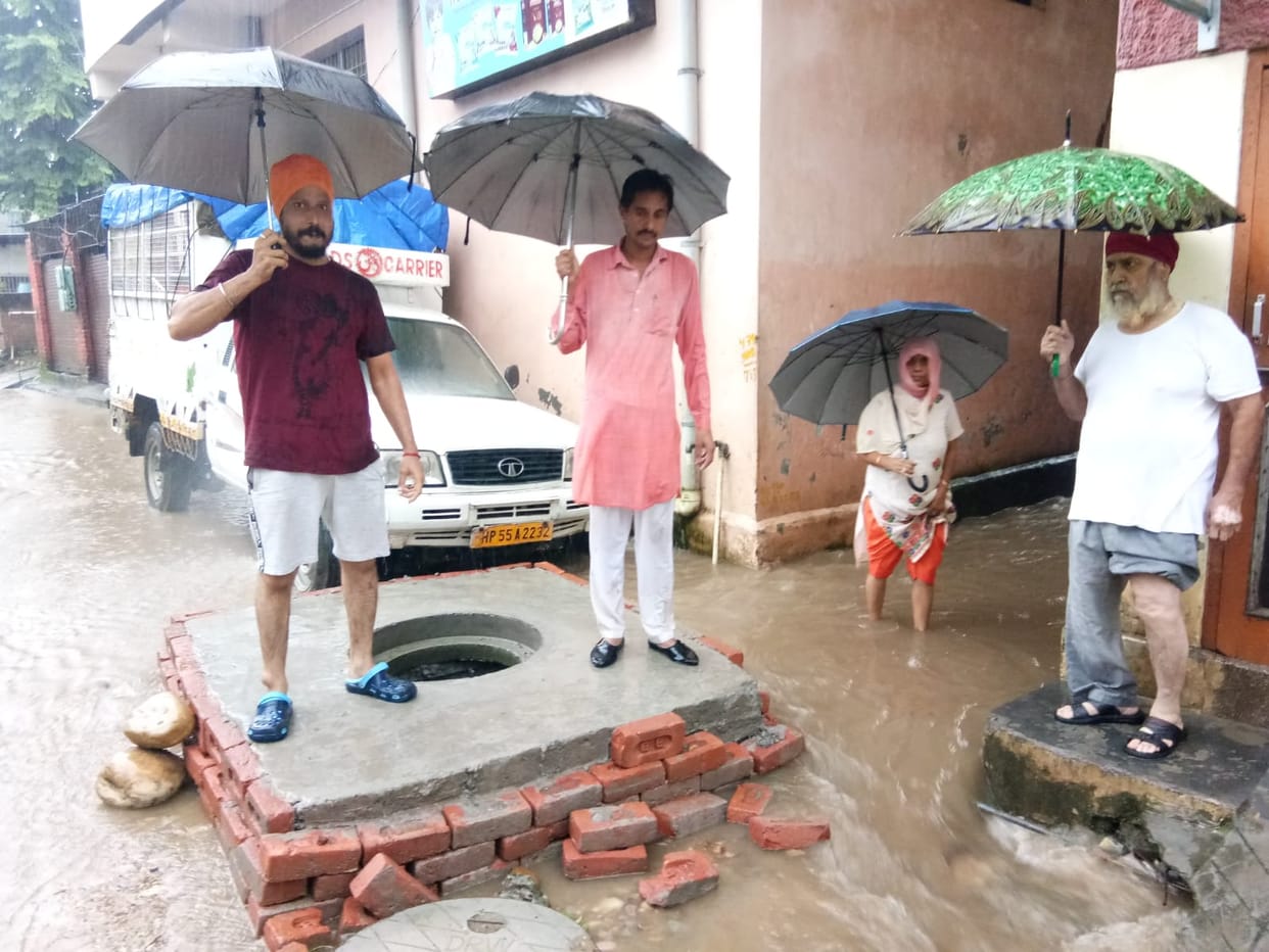 Rain water filled the street, people raised slogans