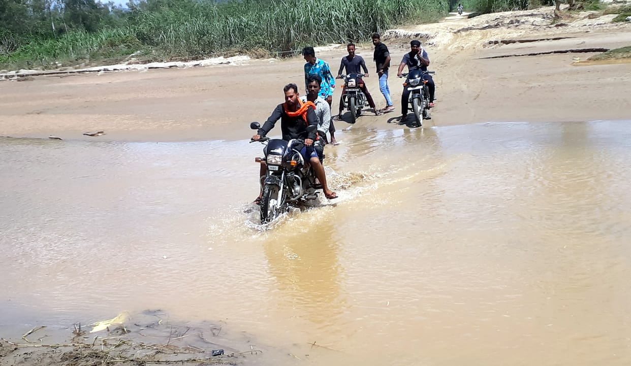 Road blocked due to rise in water level of river Dhara