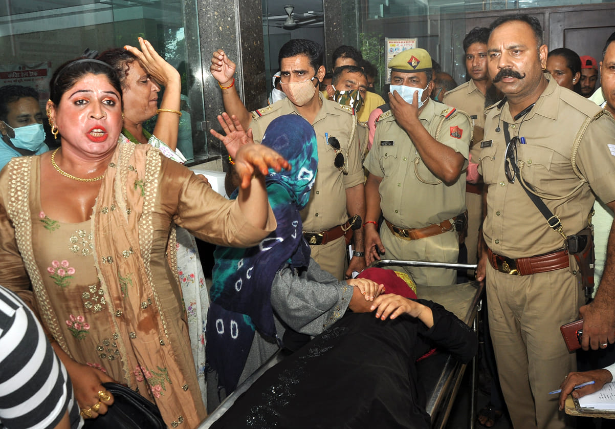 Guard's gun fired in bank, three injured including woman