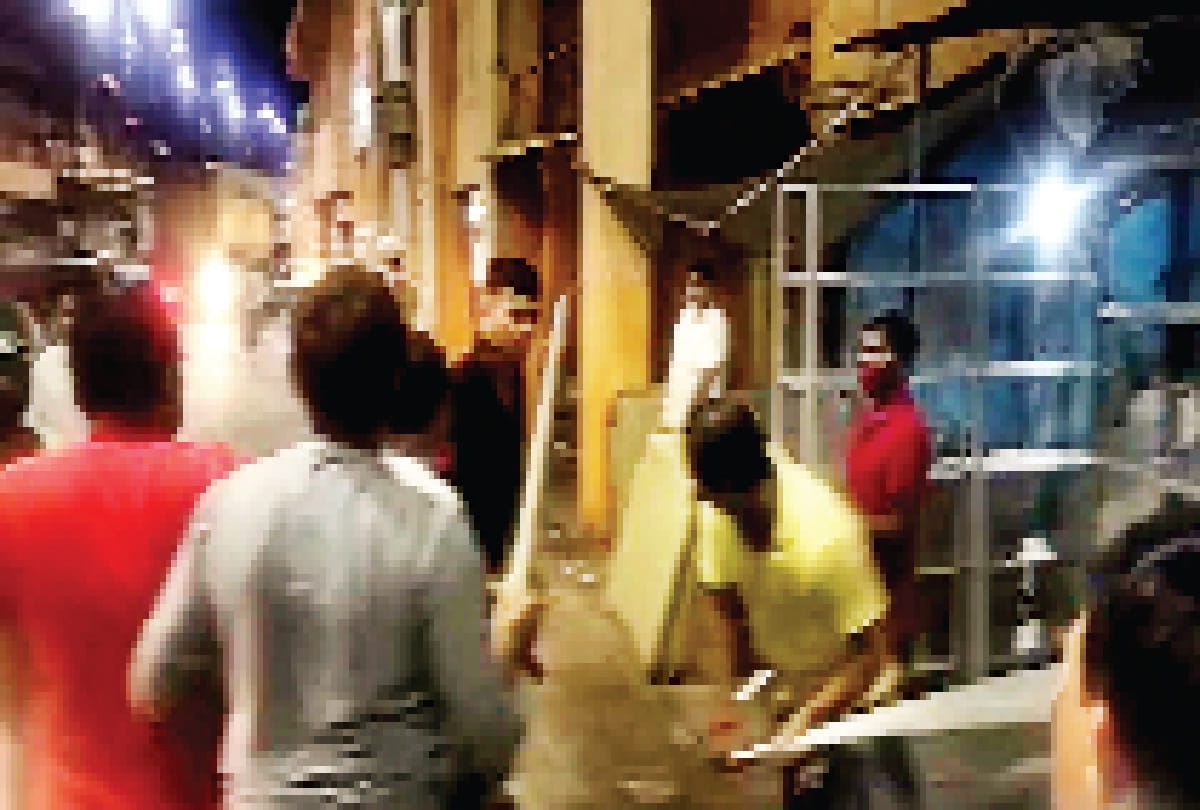 Ruckus: Youths who were shouting slogans outside cabinet minister Nandi's house, thrashing themselves as supporters of Rajabhaiya