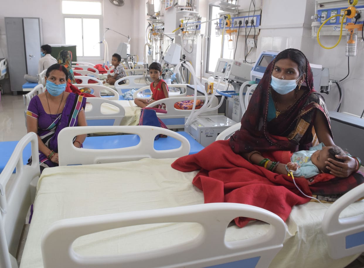 oman dies of fever, three children admitted