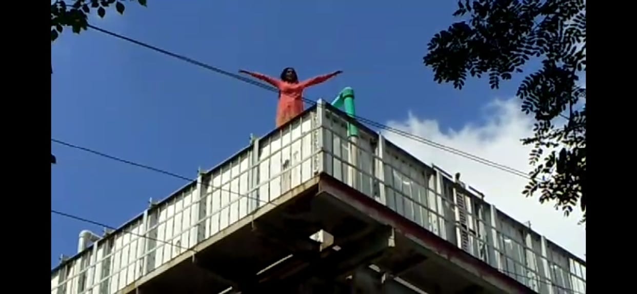 Woman climbs on dilapidated water tank at railway station