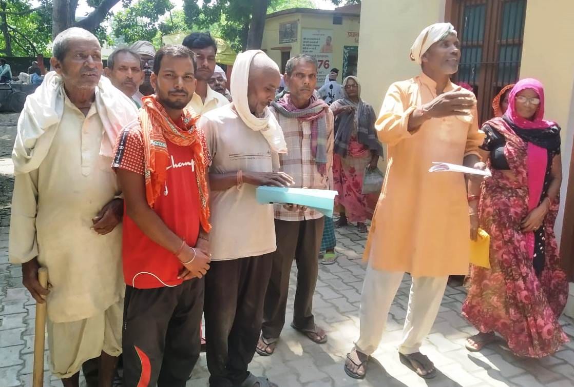 Villagers handed over a leaflet for issuing job cards