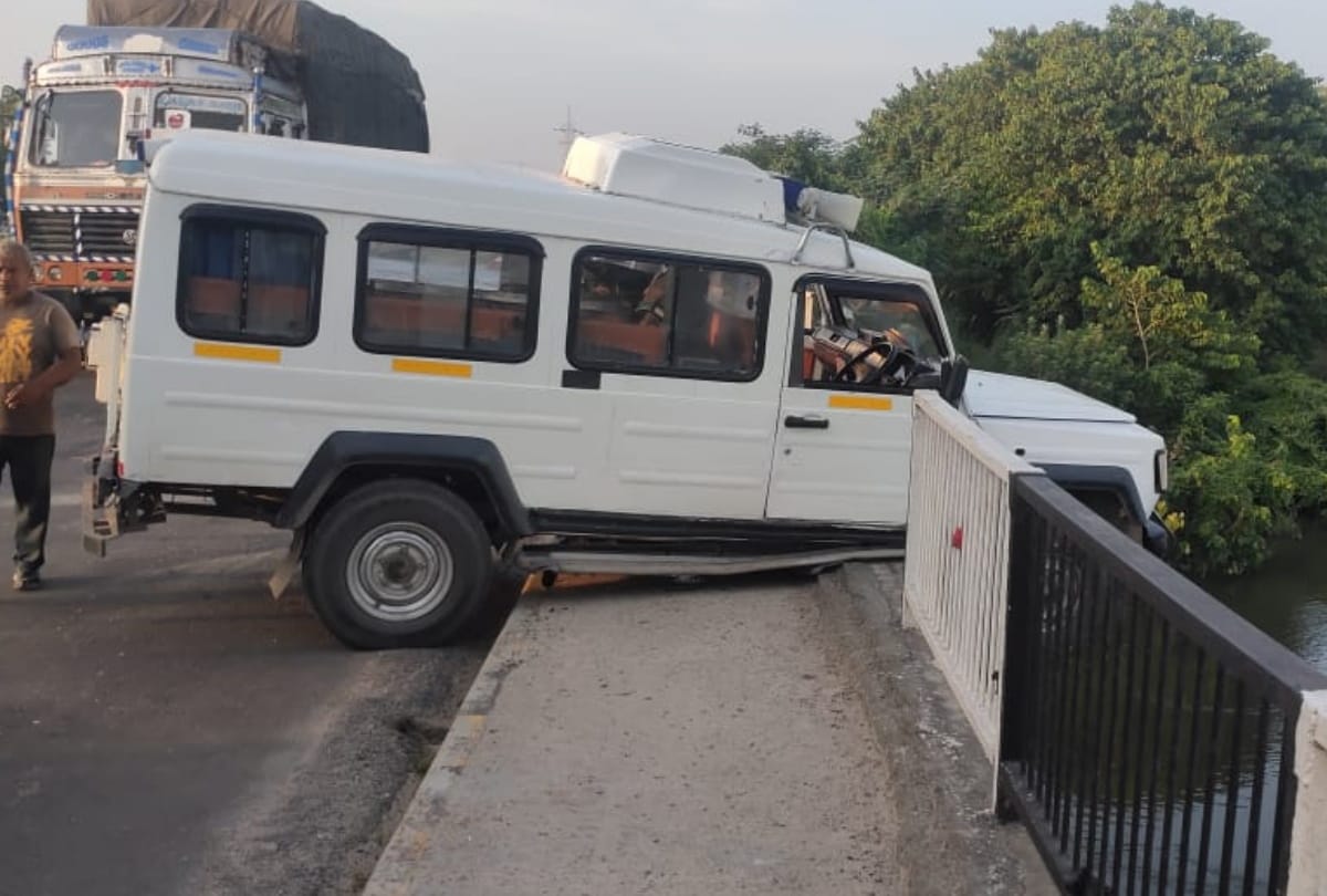 Ambulance hanging on side of river after colliding with railing of bridge in basti