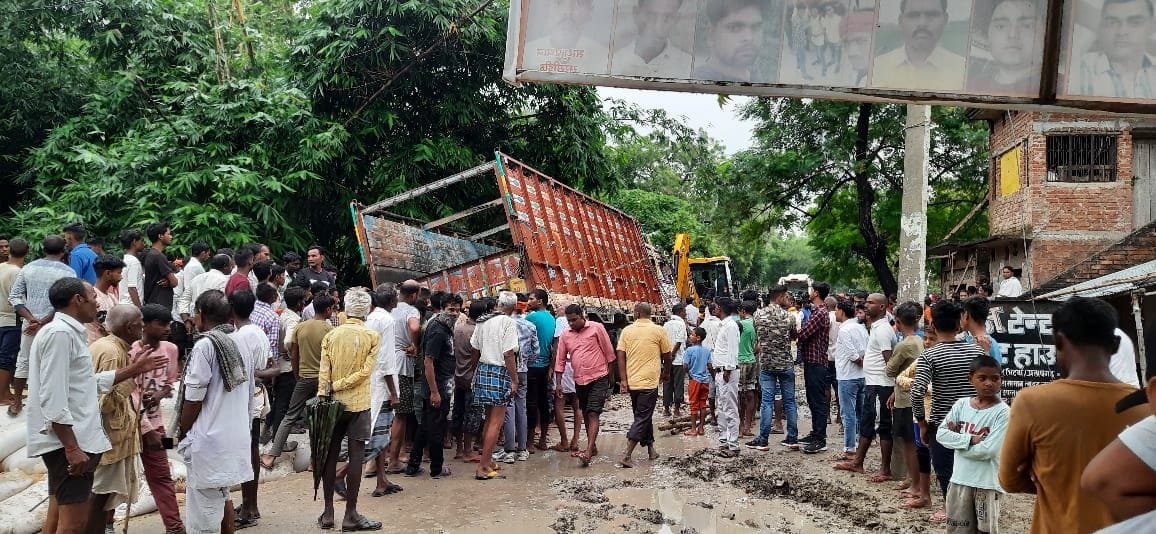 Two people died after a truck loaded with husk overturned