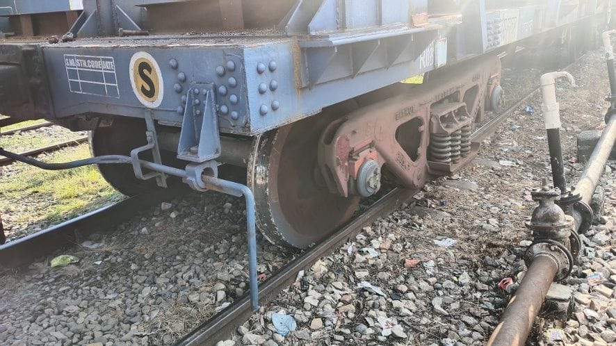 The wheel of a train laden with rail lines derailed