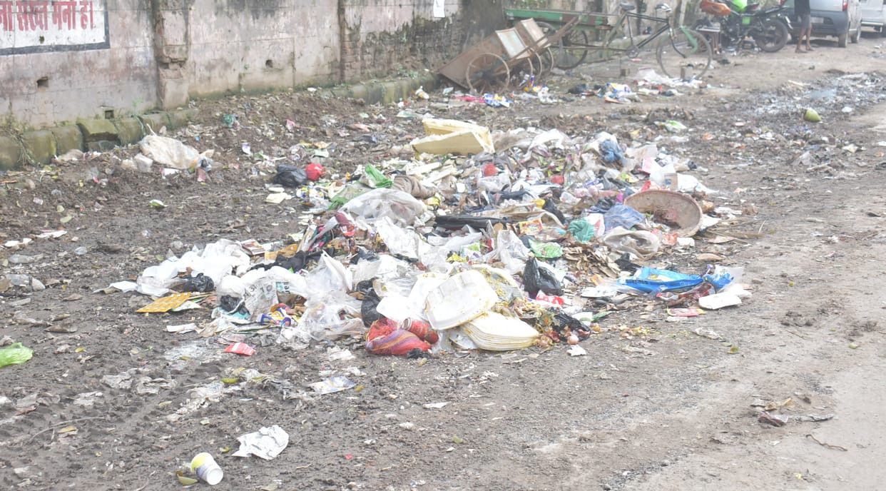 Vehicles and tube wells running by sweepers, heaps of garbage at many places