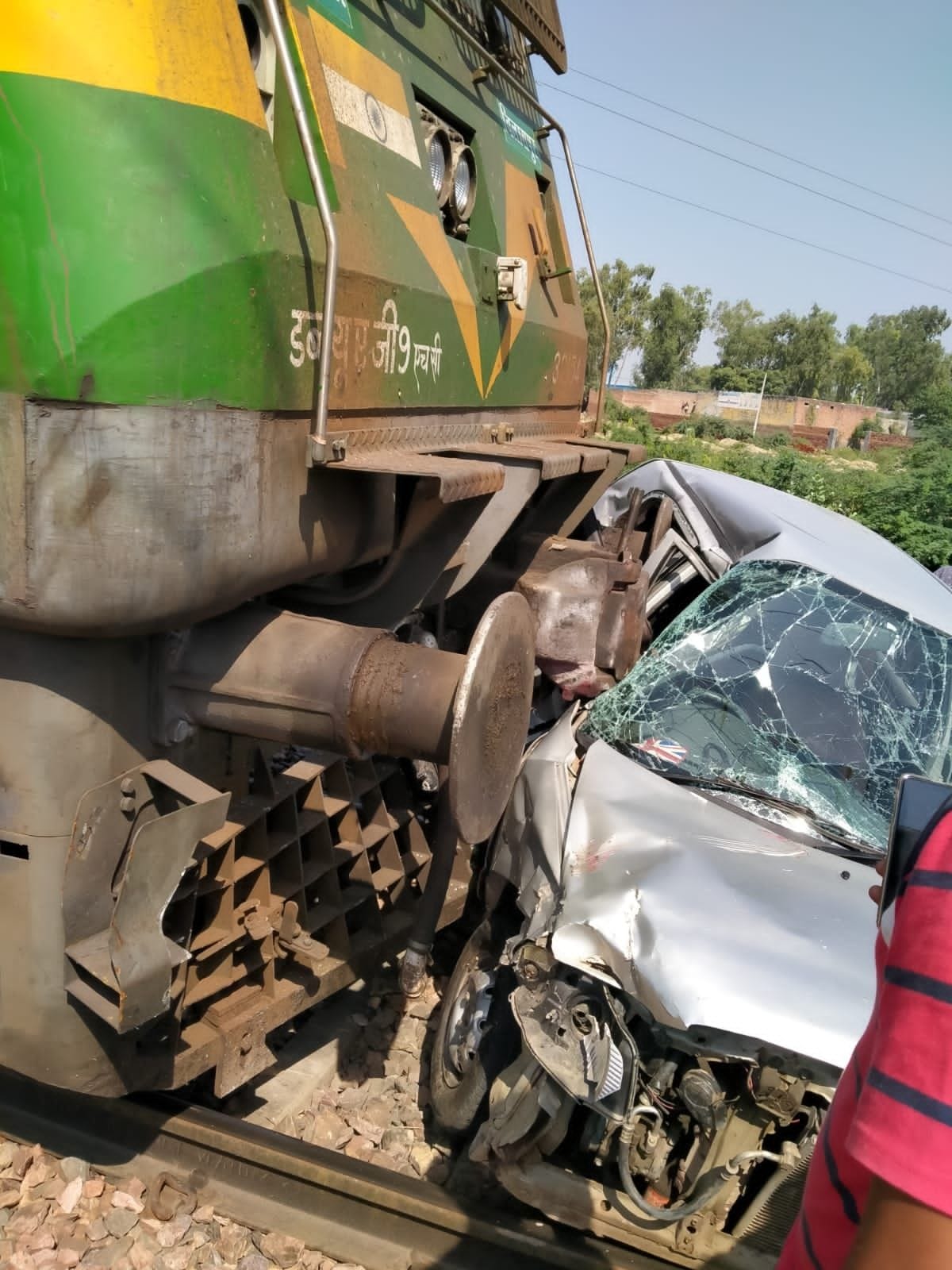 Car hit by goods train, man dies, wife injured