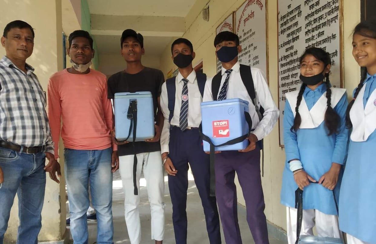 Children of Red Cross Society are giving polio drops from door to door