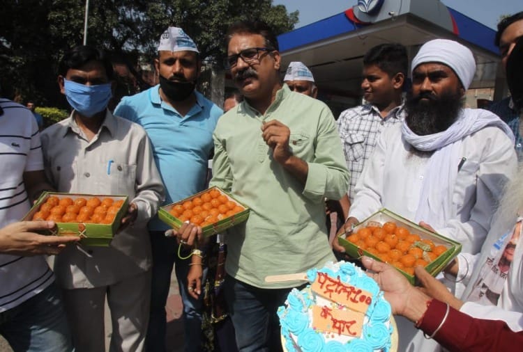 Aam Aadmi Party distributed sweets when petrol crosses Rs 100 in Chandigarh