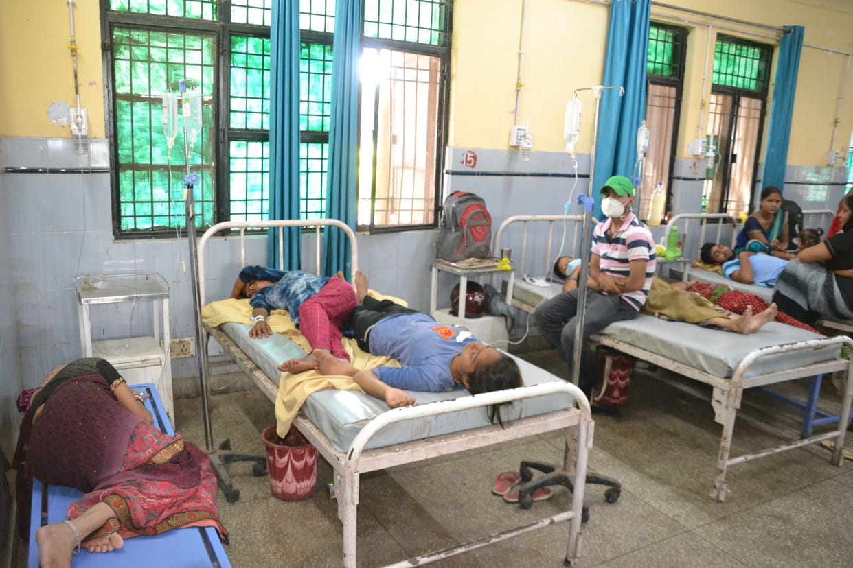 Two patients on one bed in district hospital, treated by lying on bench and floor