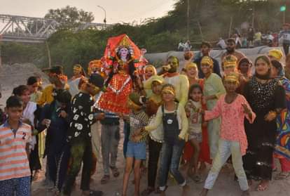 दुर्गा प्रतिमा विसर्जन के लिए ले जाते भक्त