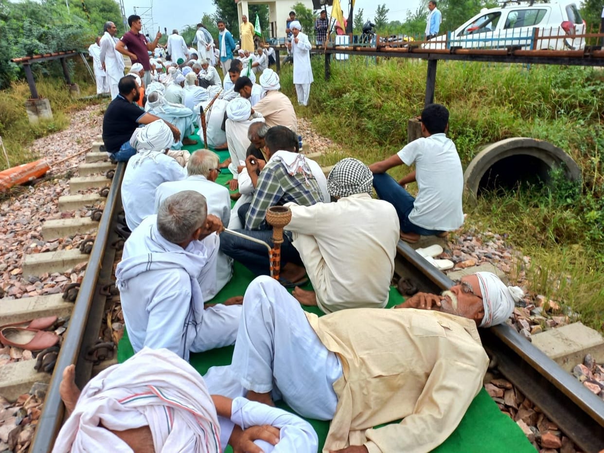 The laughter of the farmers walking on the tracks on the wheels of the trains