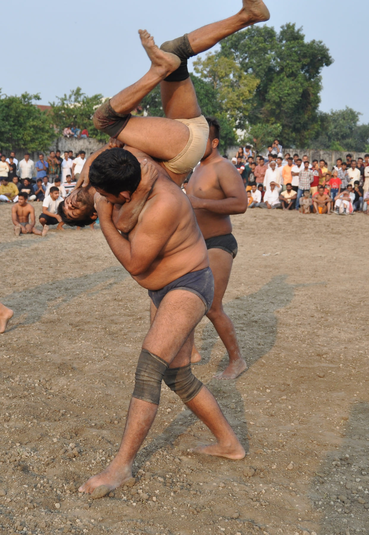 Wrestlers beat each other in wrestling