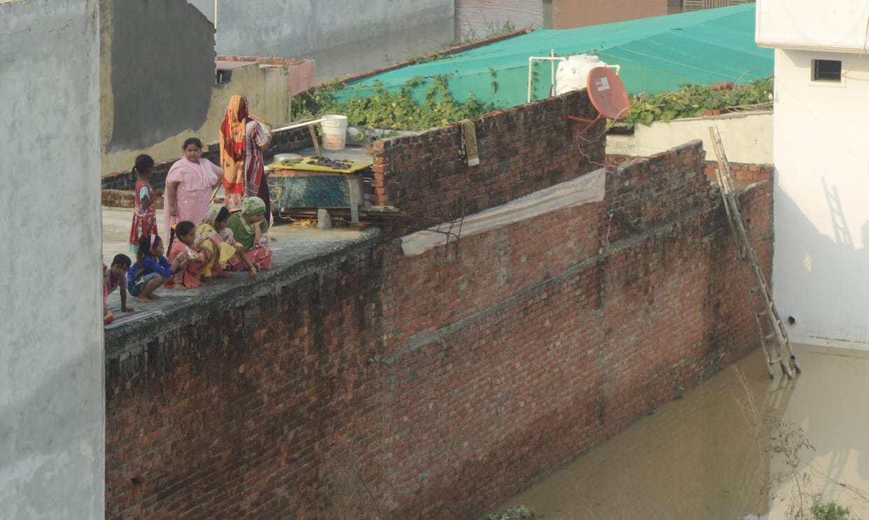 Villagers imprisoned on the roofs of houses