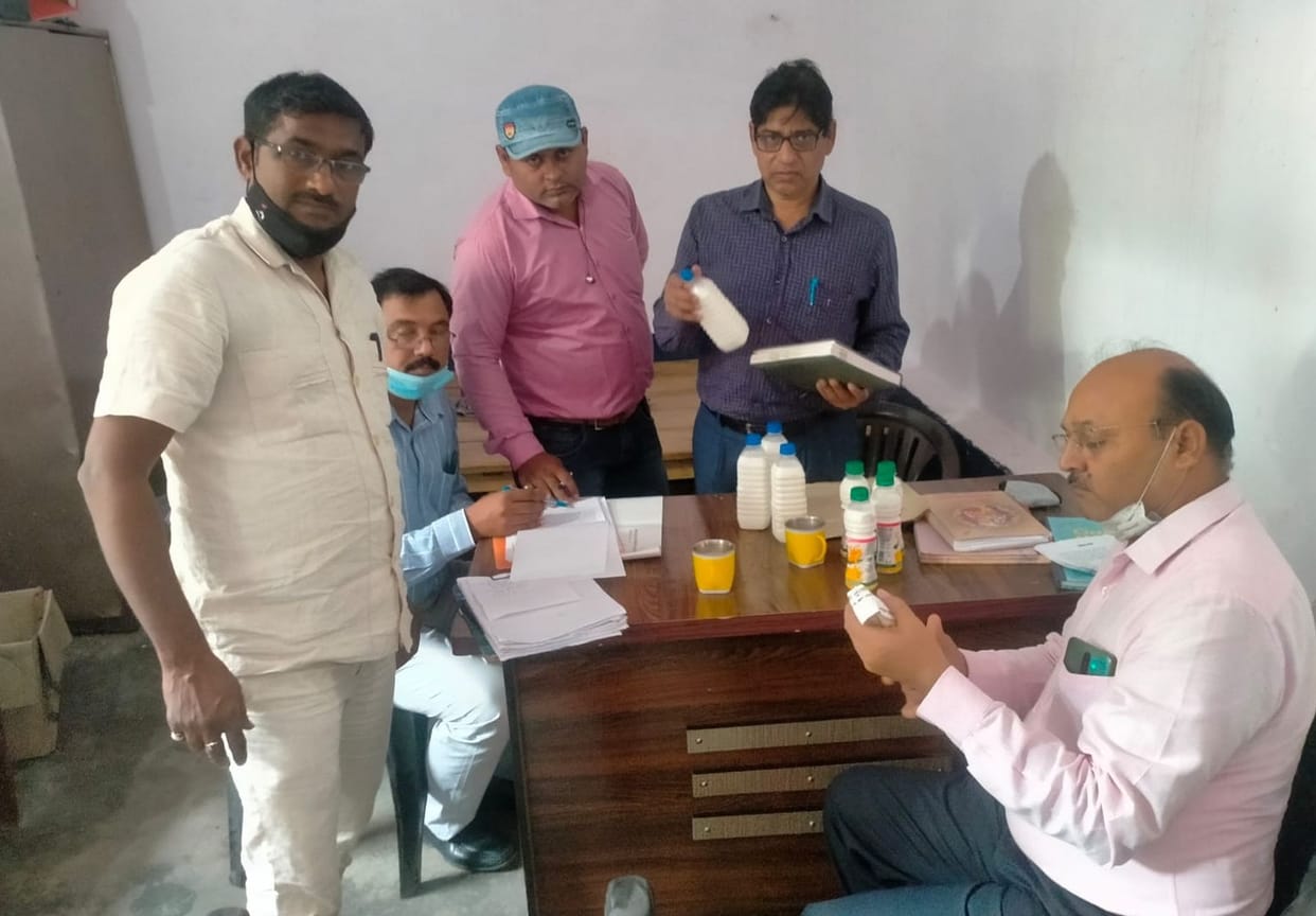 Food safety officers filled milk samples for testing