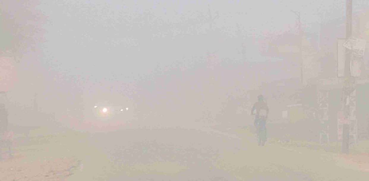 Vehicles lit with lights in dense fog