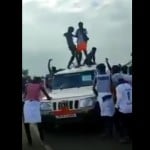 वायरल वीडियो में पुलिस कर्मियों के वाहन के ऊपर चढ़कर नाचते हुए युवक।