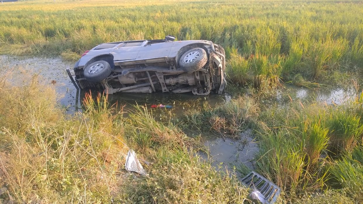 Scorpio overturned in the field after hitting the bike