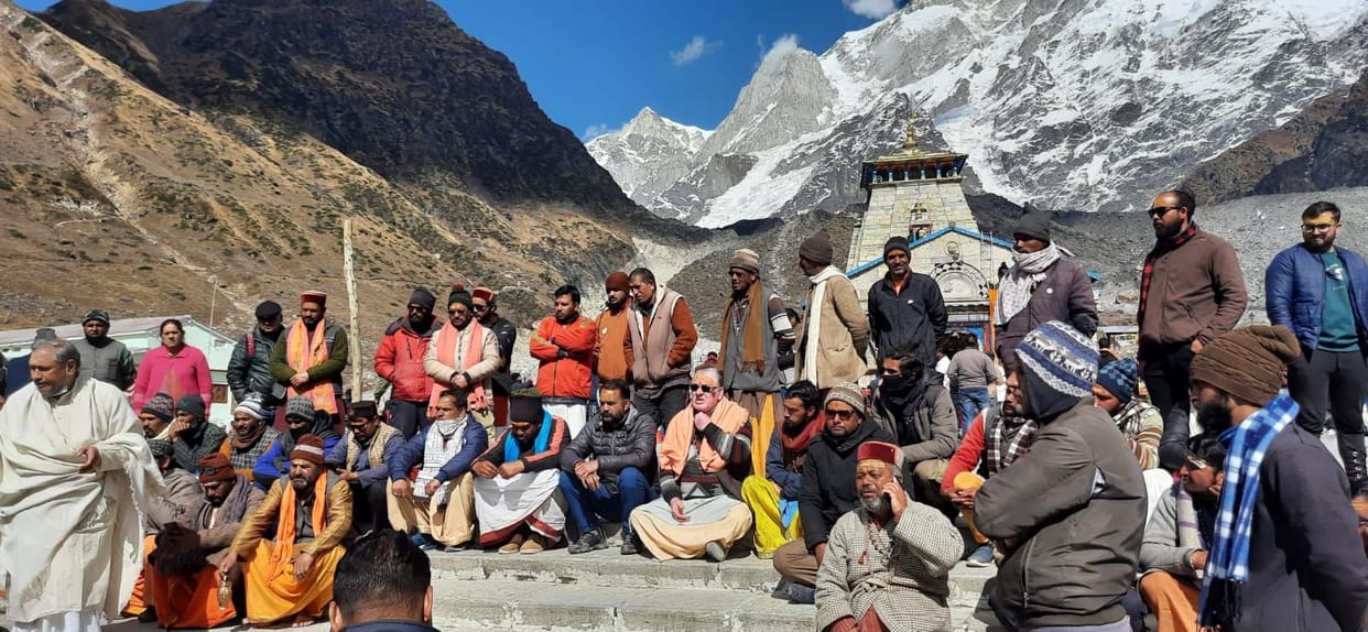 Pilgrims sitting on dharna on the steps of the temple premises
