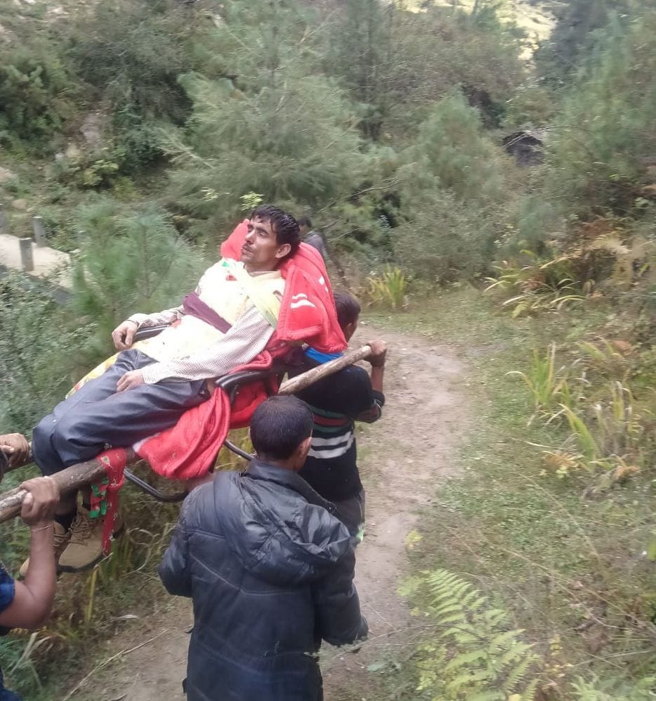 Due to lack of road, the injured person was taken to the hospital by tying him on a chair