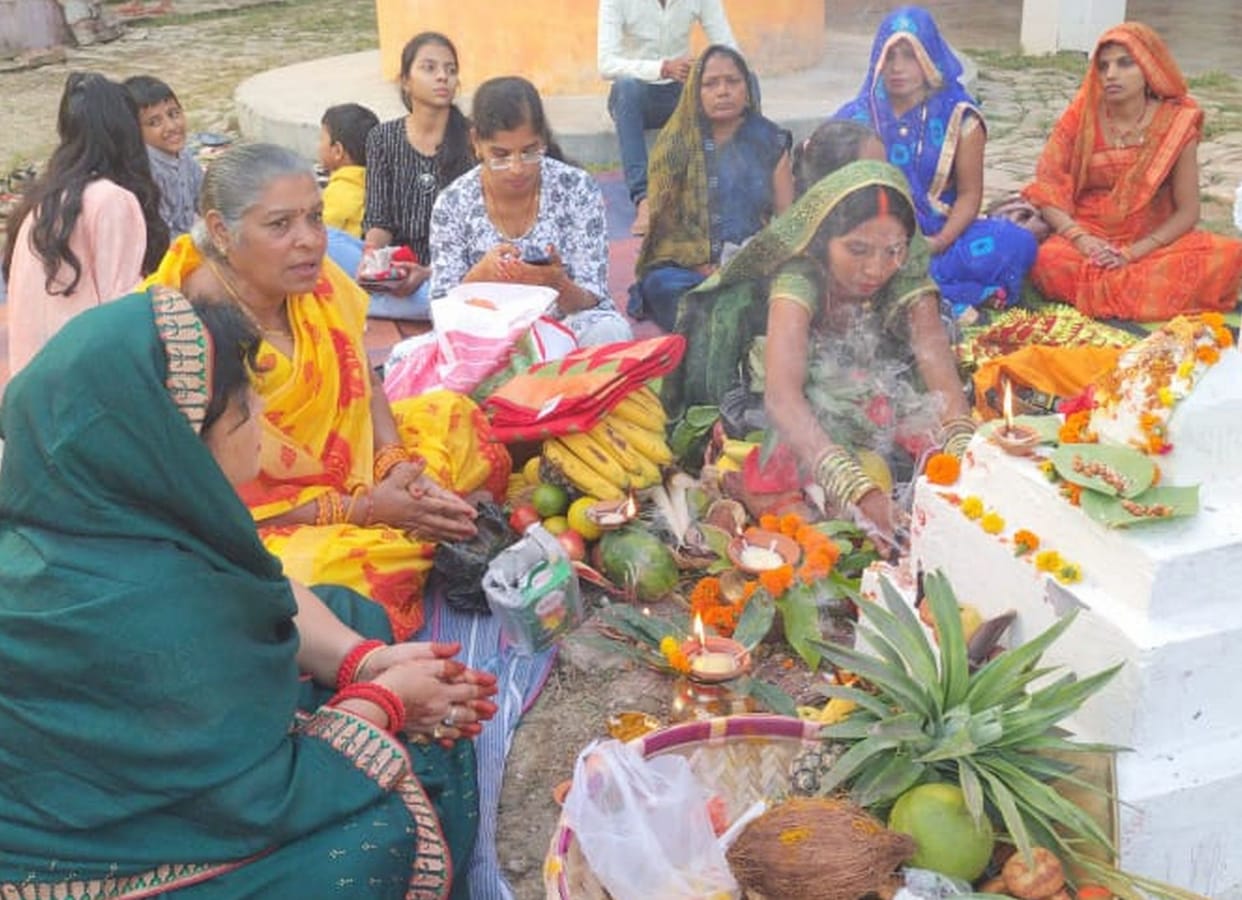Wishing for happiness and prosperity by offering arghya to the setting sun
