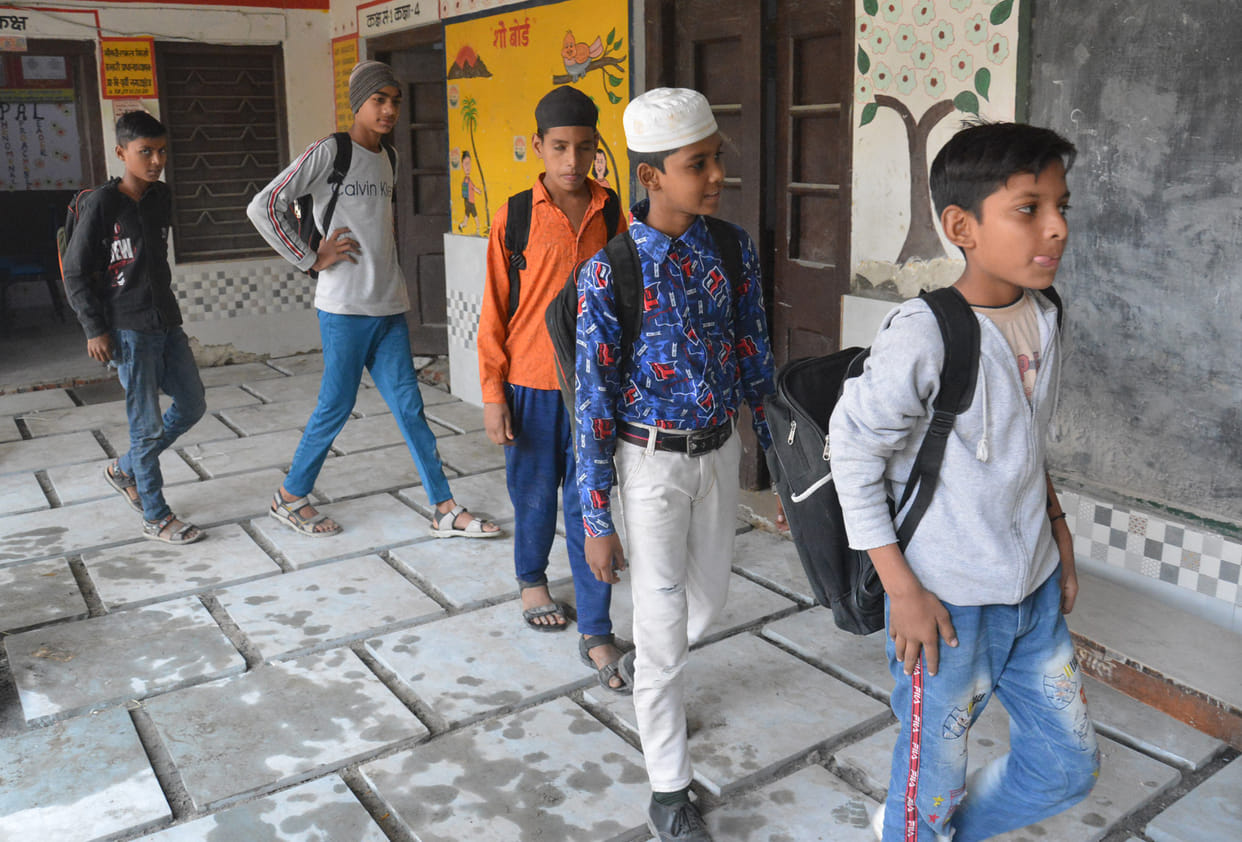 Children reaching school in winter without shoes, sweaters