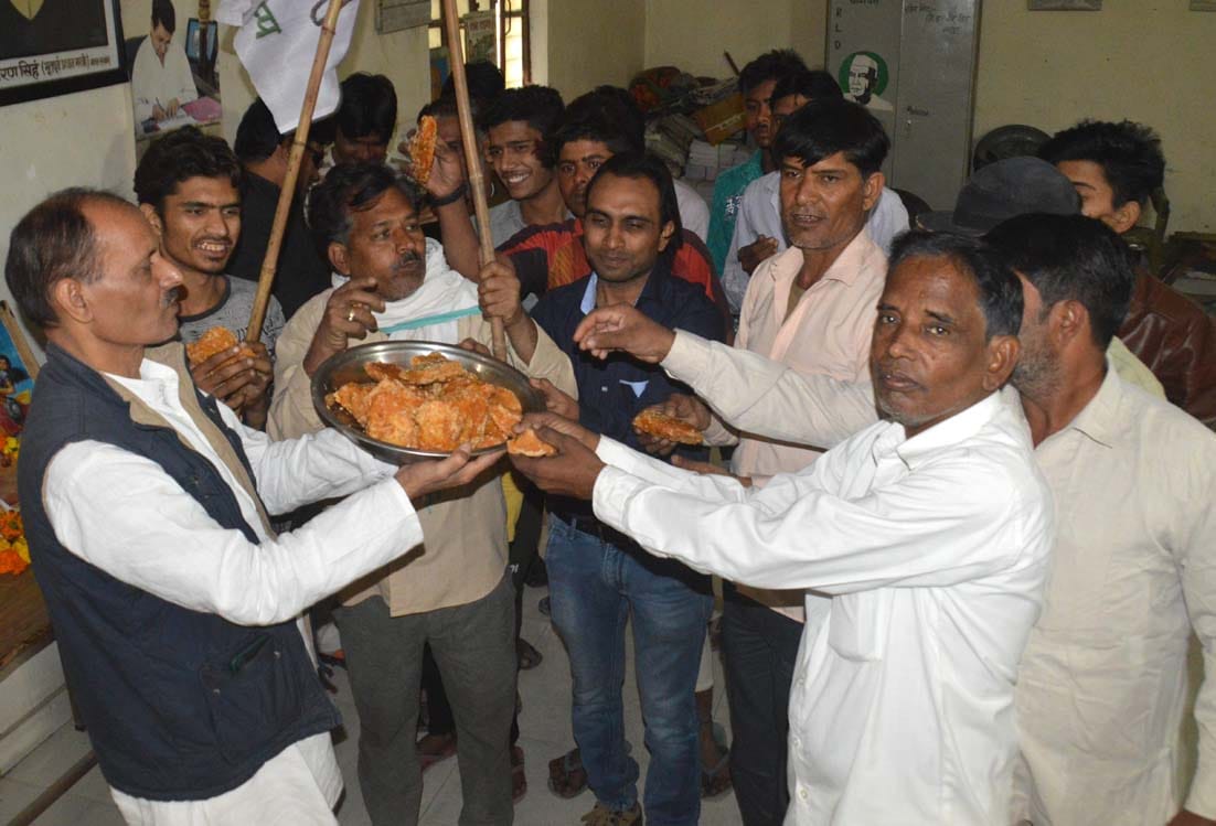 RLD workers celebrated happiness by distributing jaggery