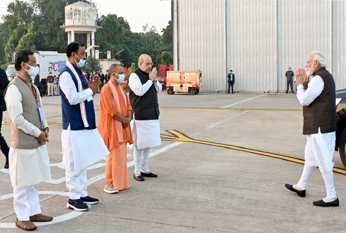 Union Home Minister Amit Shah and Chief Minister Yogi Adityanath greet Prime Minister Narendra Modi at Amausi Airport