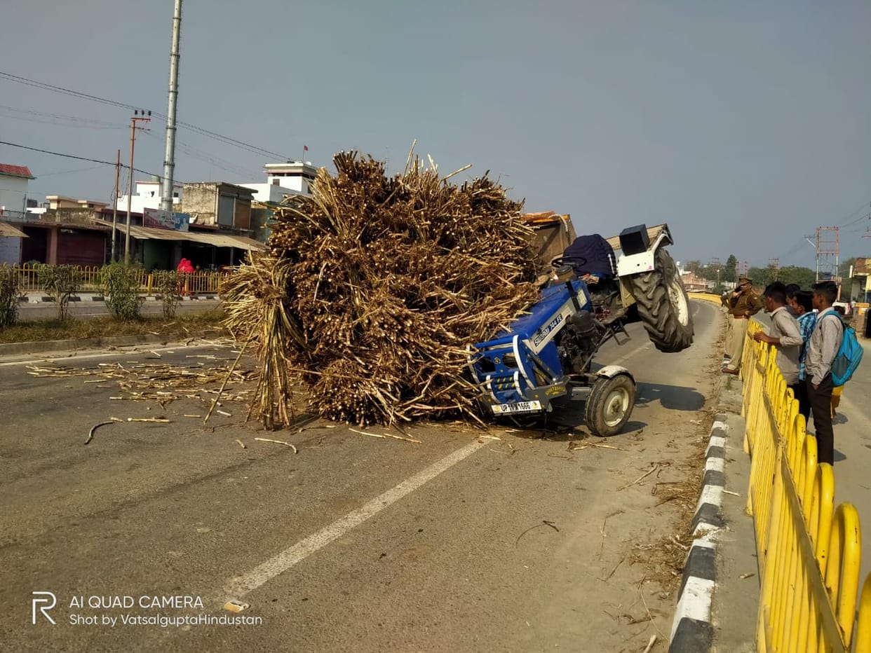 Overloaded tractor trolley full of sugarcane overturned on the highway