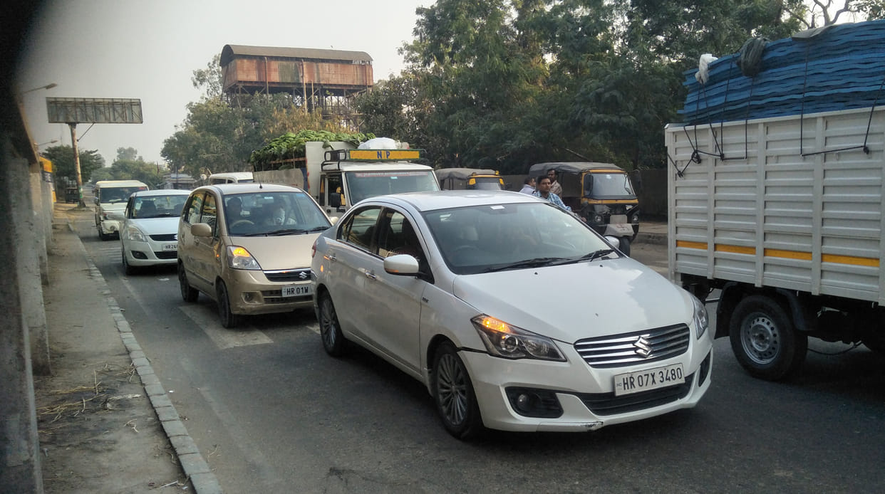 Autos and roadways buses parked on the road are causing jam, common people and drivers are getting upset