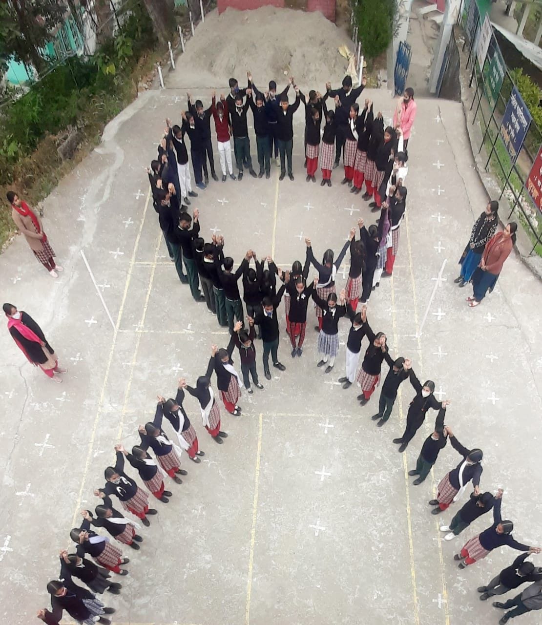 Children made a red ribbon and gave a message to fight against AIDS