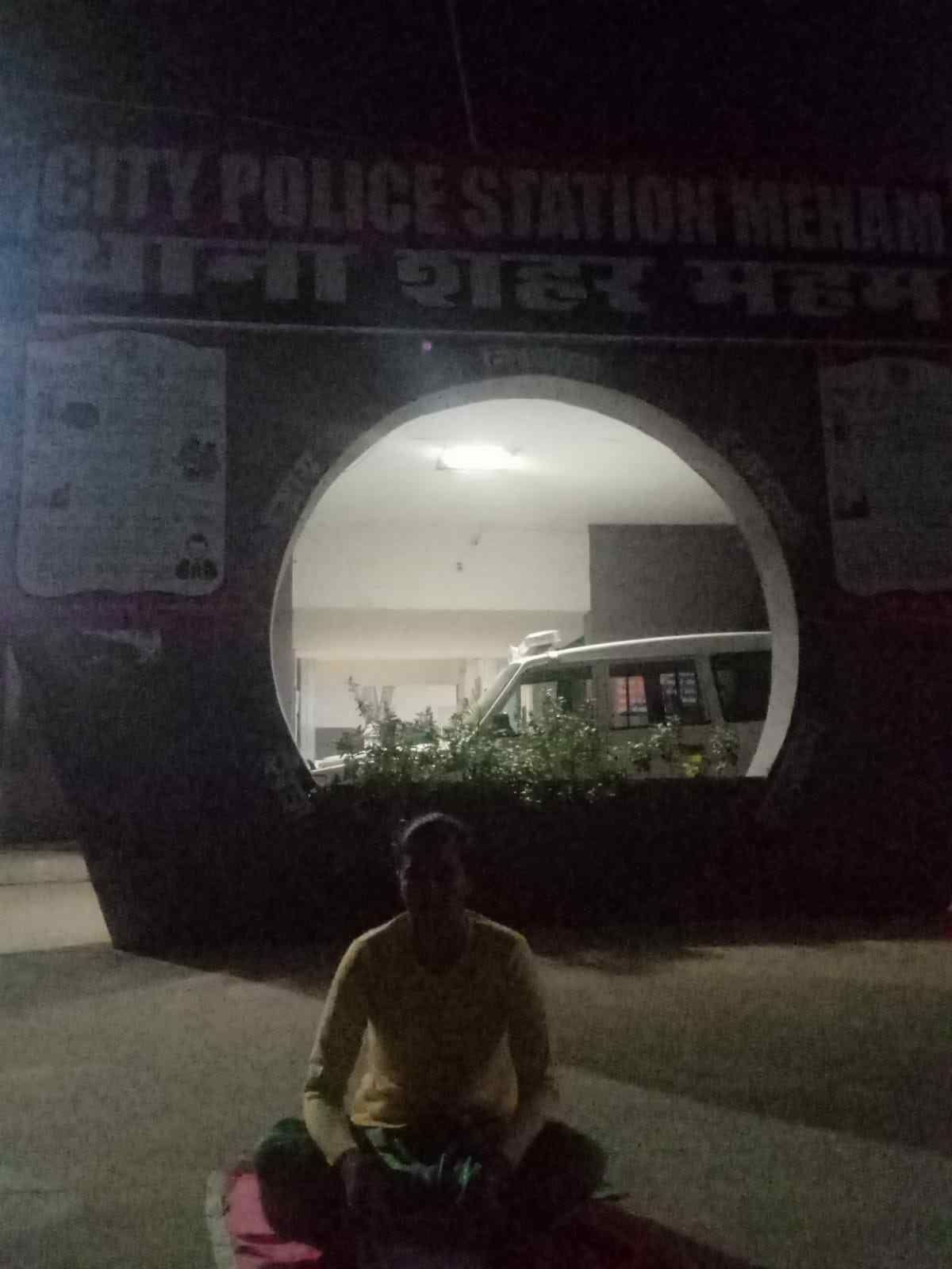 Angry woman sitting outside police station after getting bail to husband and mother-in-law