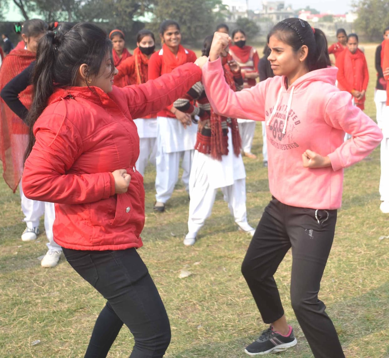Teach self defense tricks to girl students in the camp