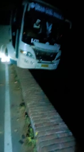 Double decker bus hanging from the railing of the narrow bridge of the canal