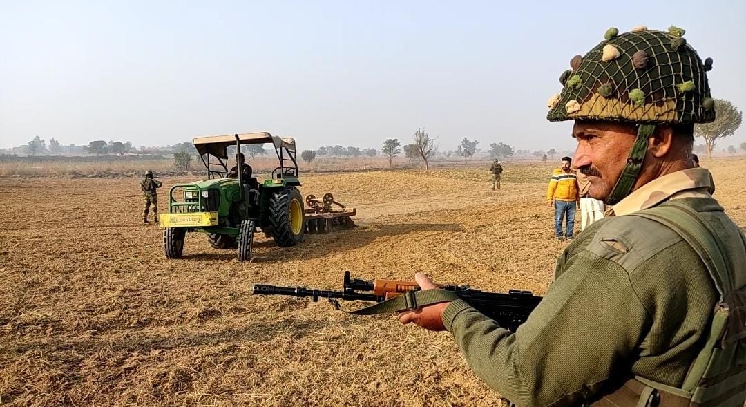 BSF personnel walking with tractor to protect farmers