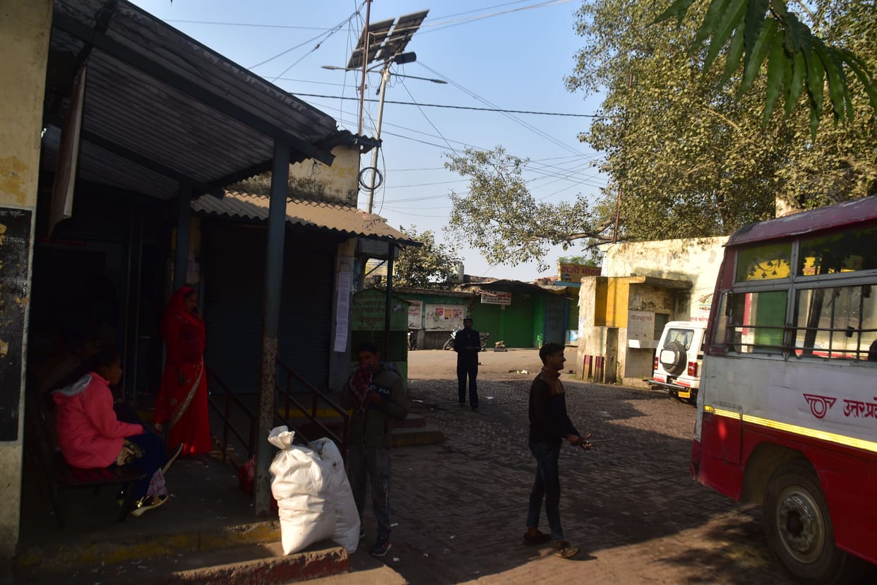 Standing in the open, passengers wait for roadways buses