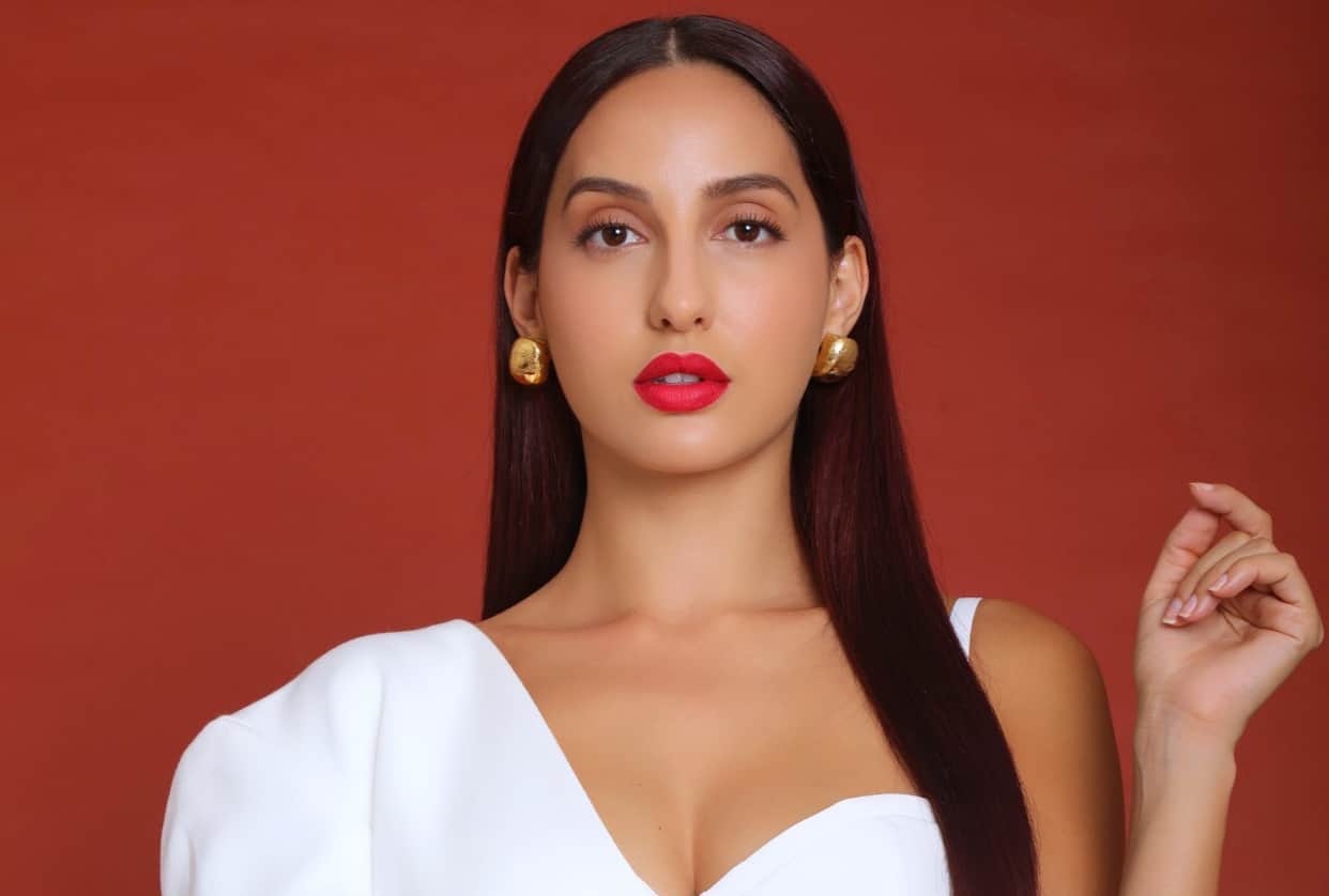 nora fatehi flaunts curvy figure in silver midi dress